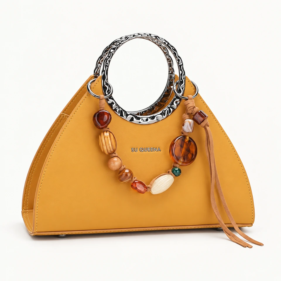 SU QUEENA3203 mustard-yellow bag with silver ring handles and bead charm.