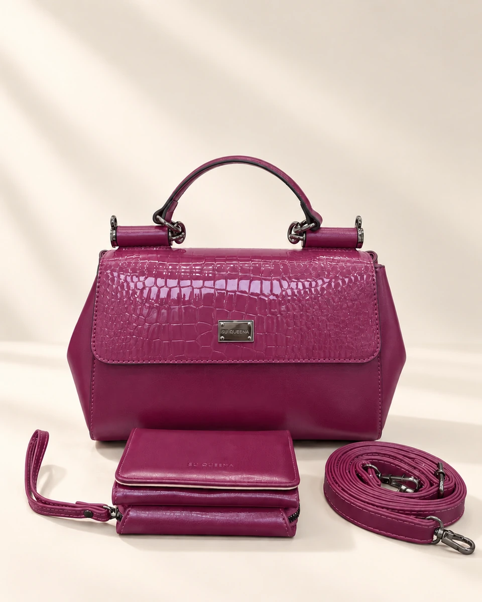 Model 3232, muted plum top-handle bag shown with a wallet and coiled shoulder strap.
